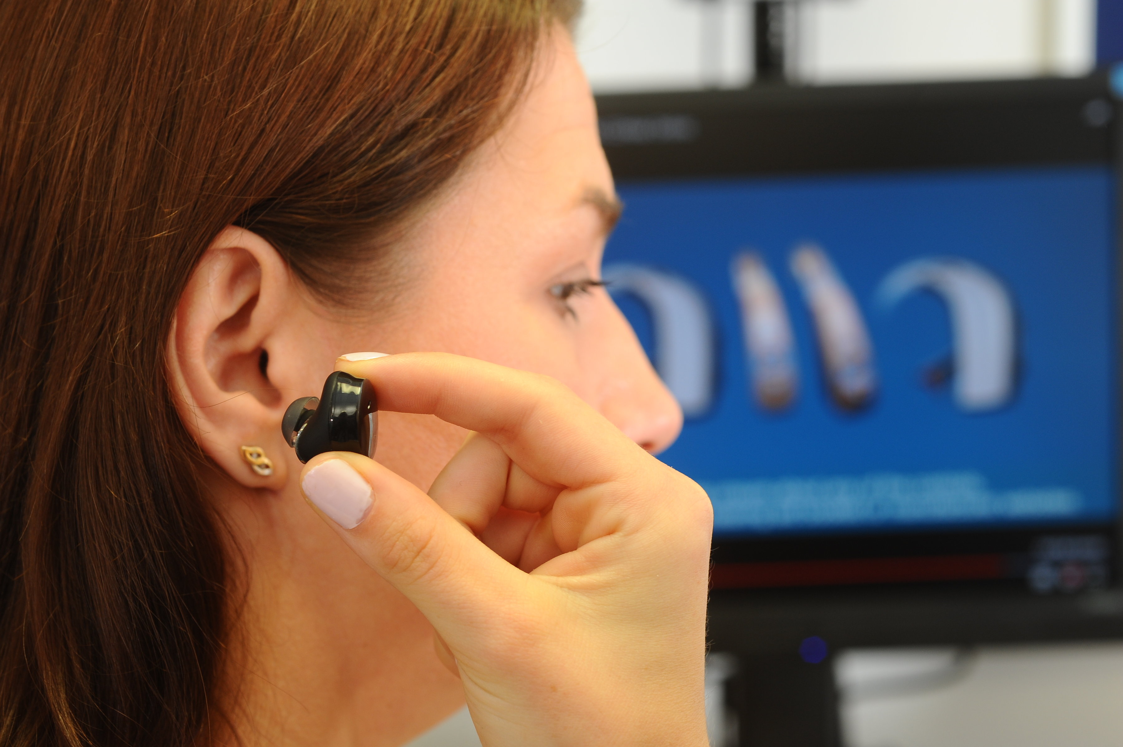 Person putting earbuds in